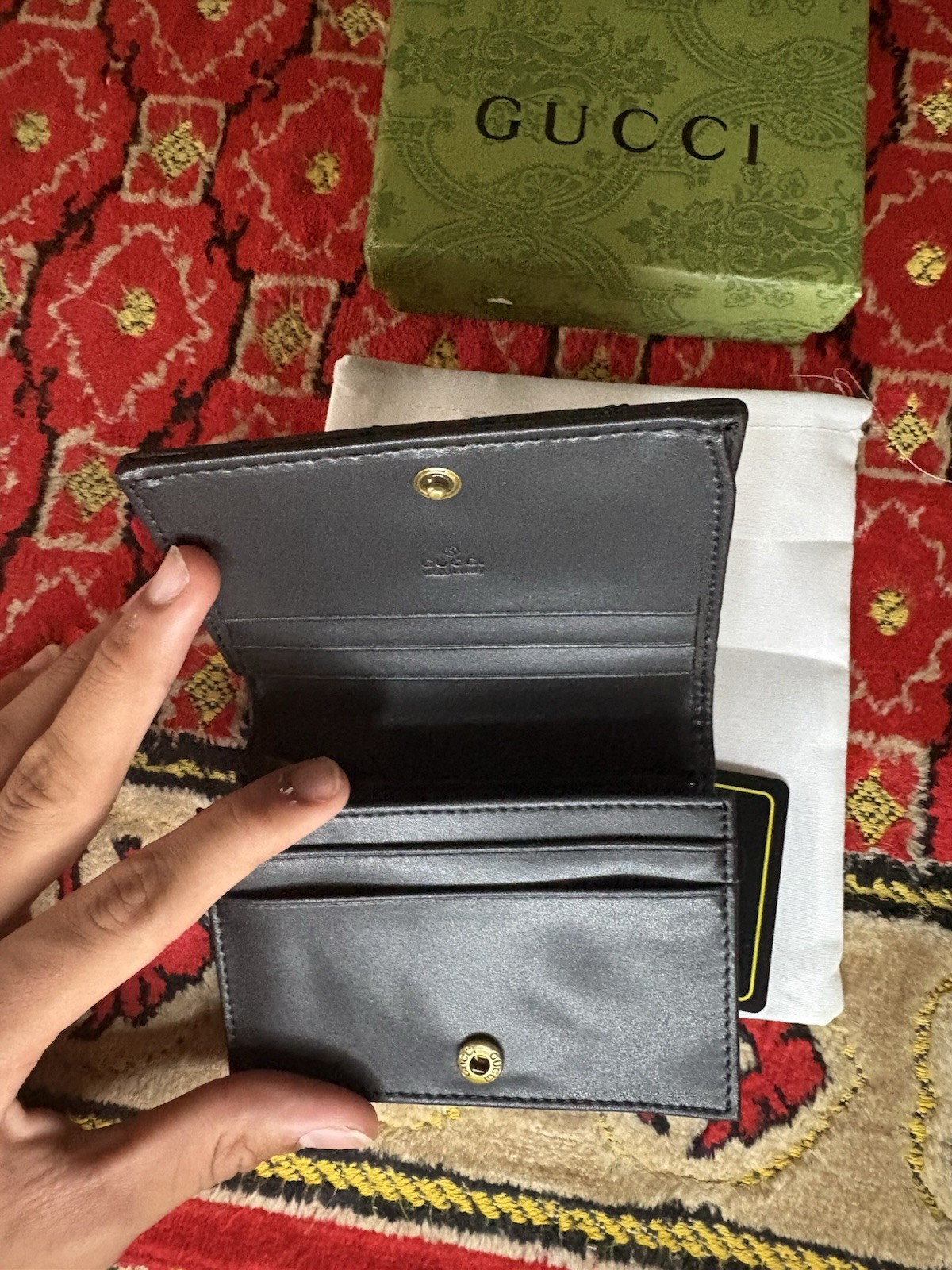 Gucci GG Marmont card case wallet in black quilted chevron leather.