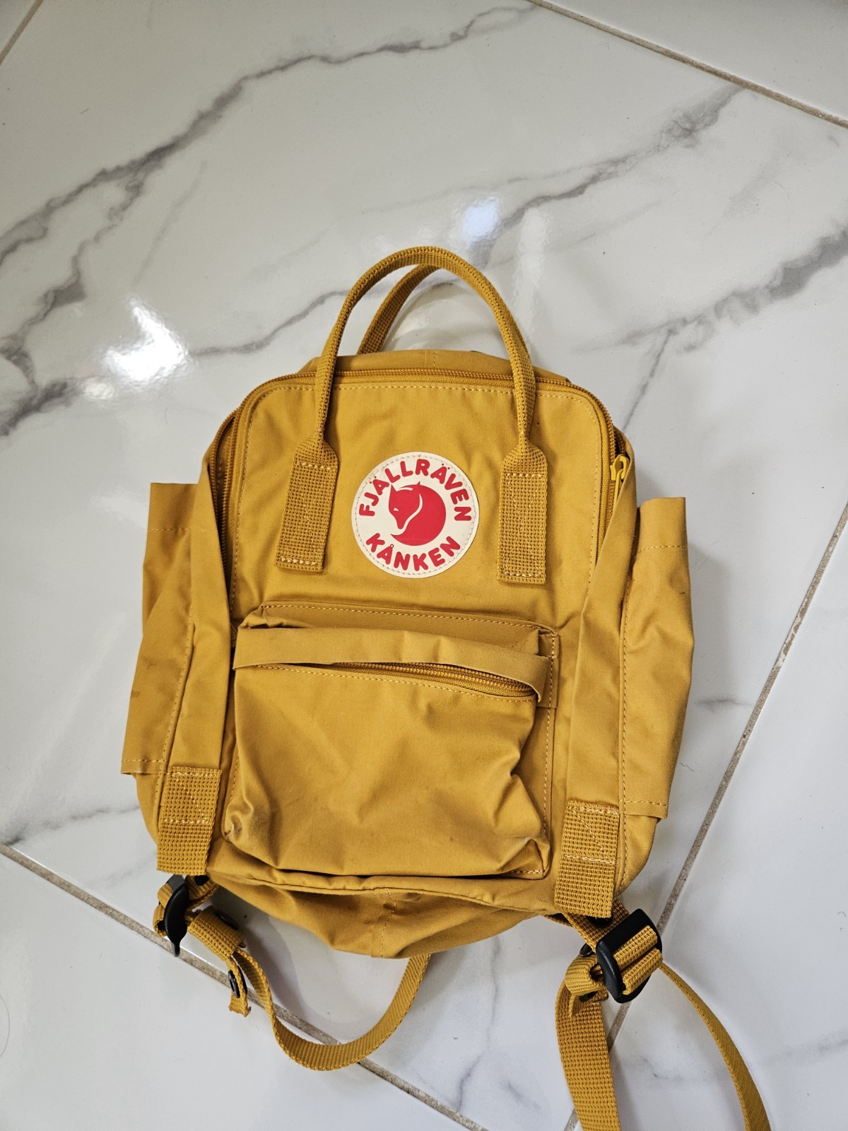 Fjällräven Kånken meduim yellow backpack.