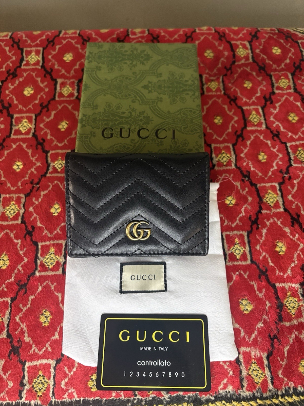 Gucci GG Marmont card case wallet in black quilted chevron leather.