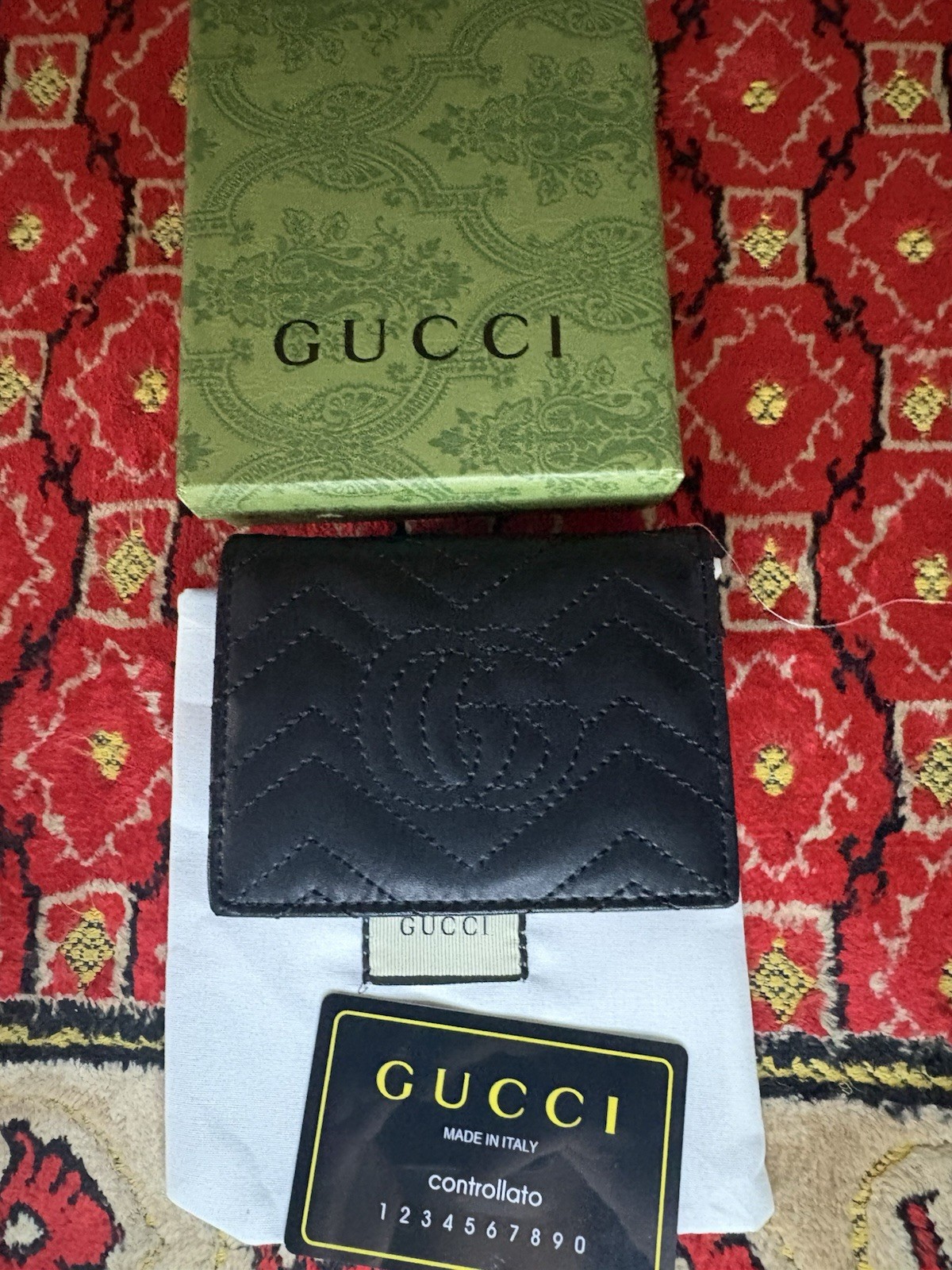 Gucci GG Marmont card case wallet in black quilted chevron leather.