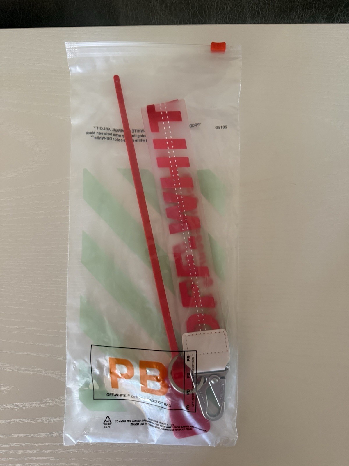 Off-White Red Strap Key Chain with Metal Clip, Logo Accents, Plastic/Metal (Red)