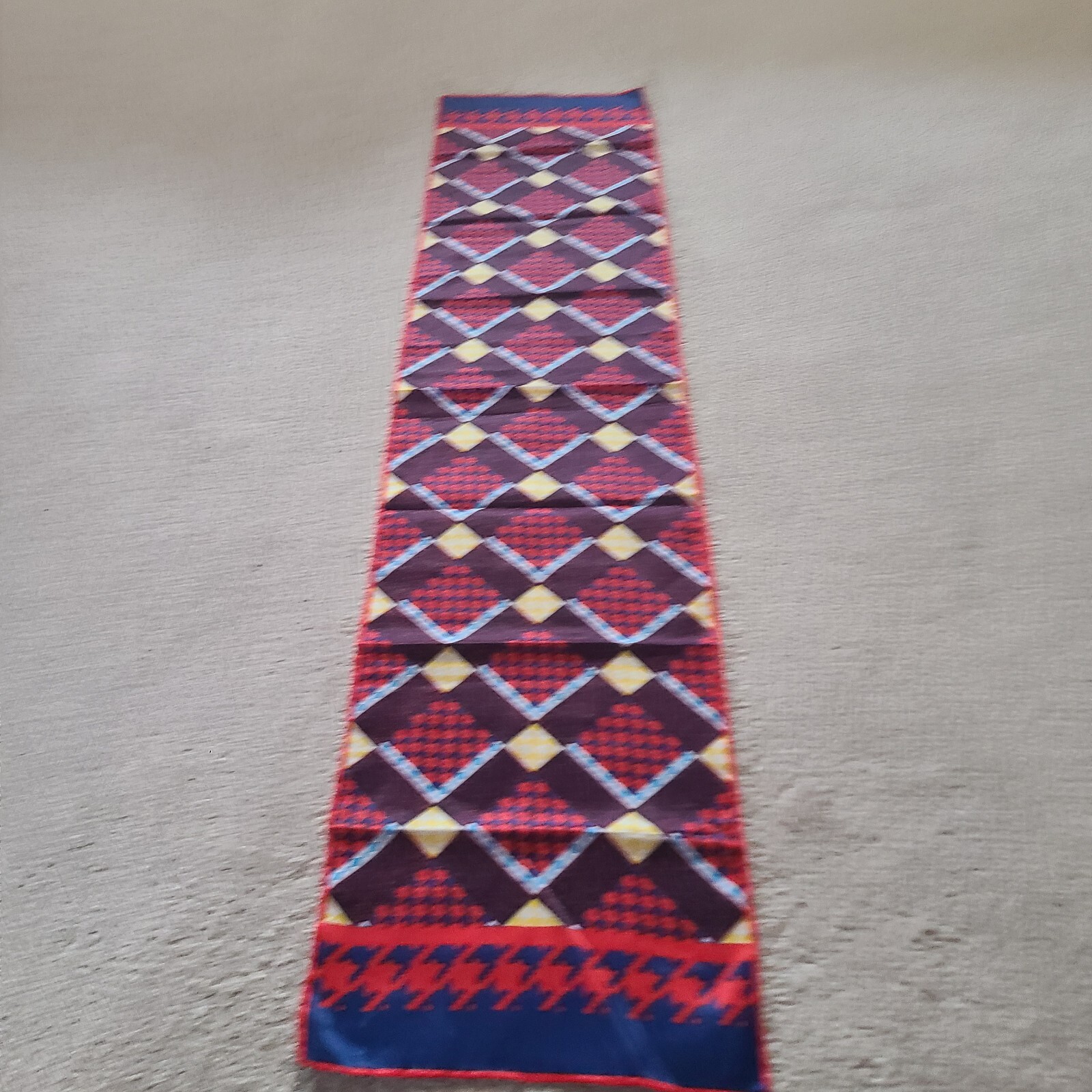 Scarf rectangular geometric pattern in red blue. Unmarked. 43 x 9.75 in.