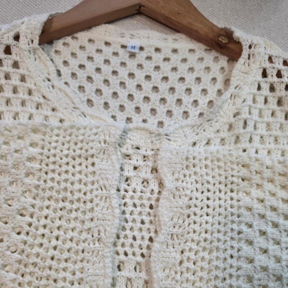 Cream crochet sweater with open knit design
