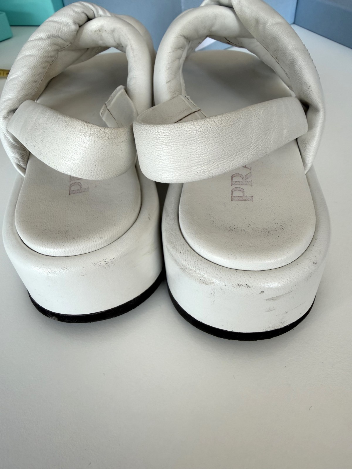 Women’s PRADA Padded Nappa Leather Flatform Sandals in white. Size: 38.5 EU