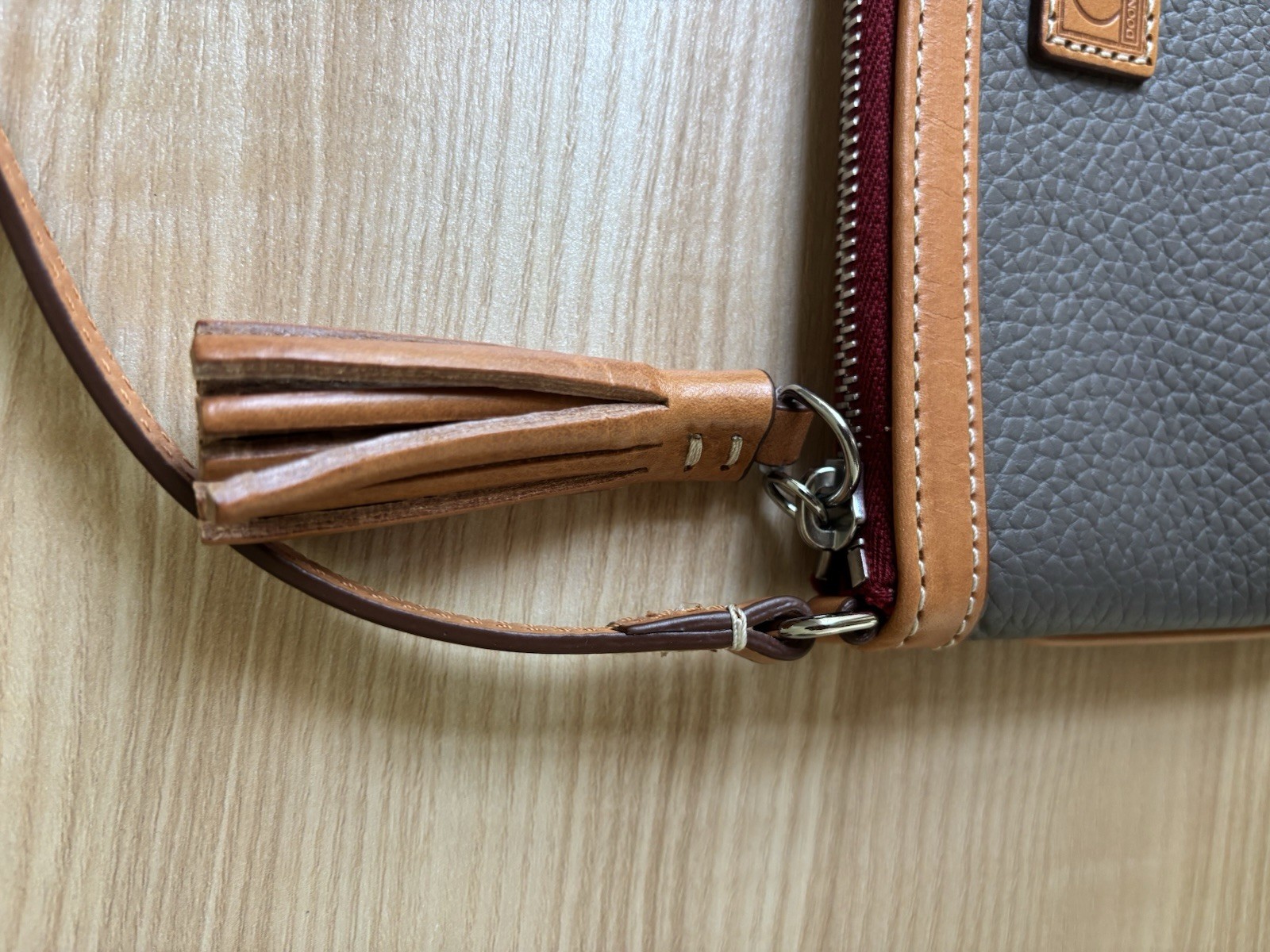 Dooney & Bourke Pebbled Zip Top mini bag with Brown Tan Detachable Strap Tassel