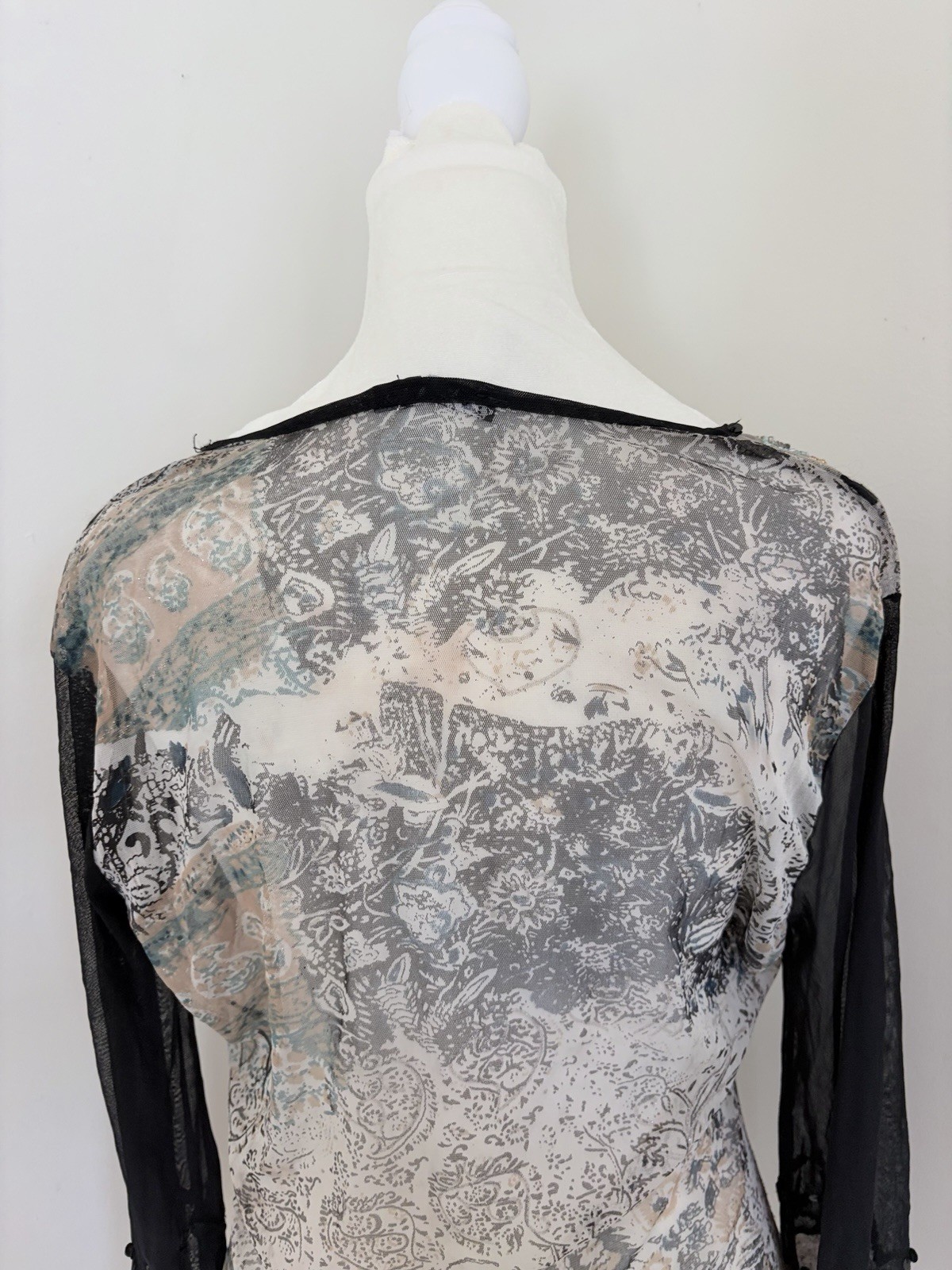 Vintage long sleeve top features a grey and black paisley print with intricate b