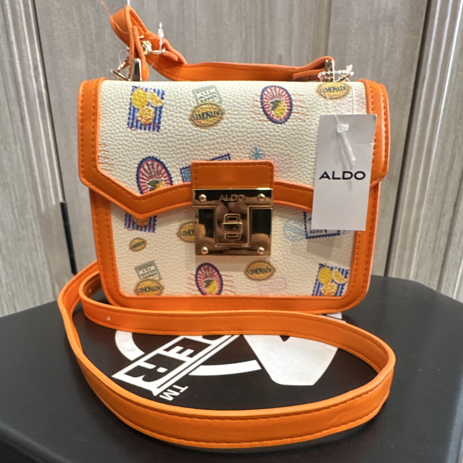 ALDO Women’s Postage Stamp Print Crossbody Turn Lock, Orange/White