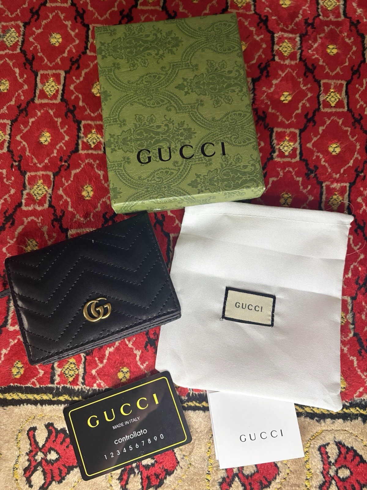 Gucci GG Marmont card case wallet in black quilted chevron leather.