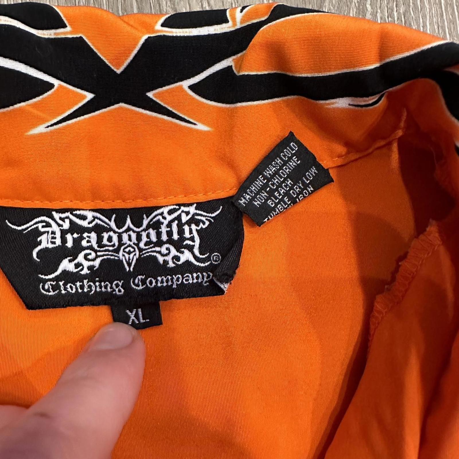 Orange and black dragon button up shirt with a small hole can be sewed size xl