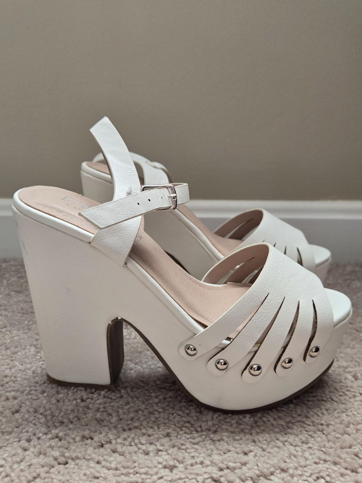 Brand new. Never worn. White faux soft leather high heels with wide heel