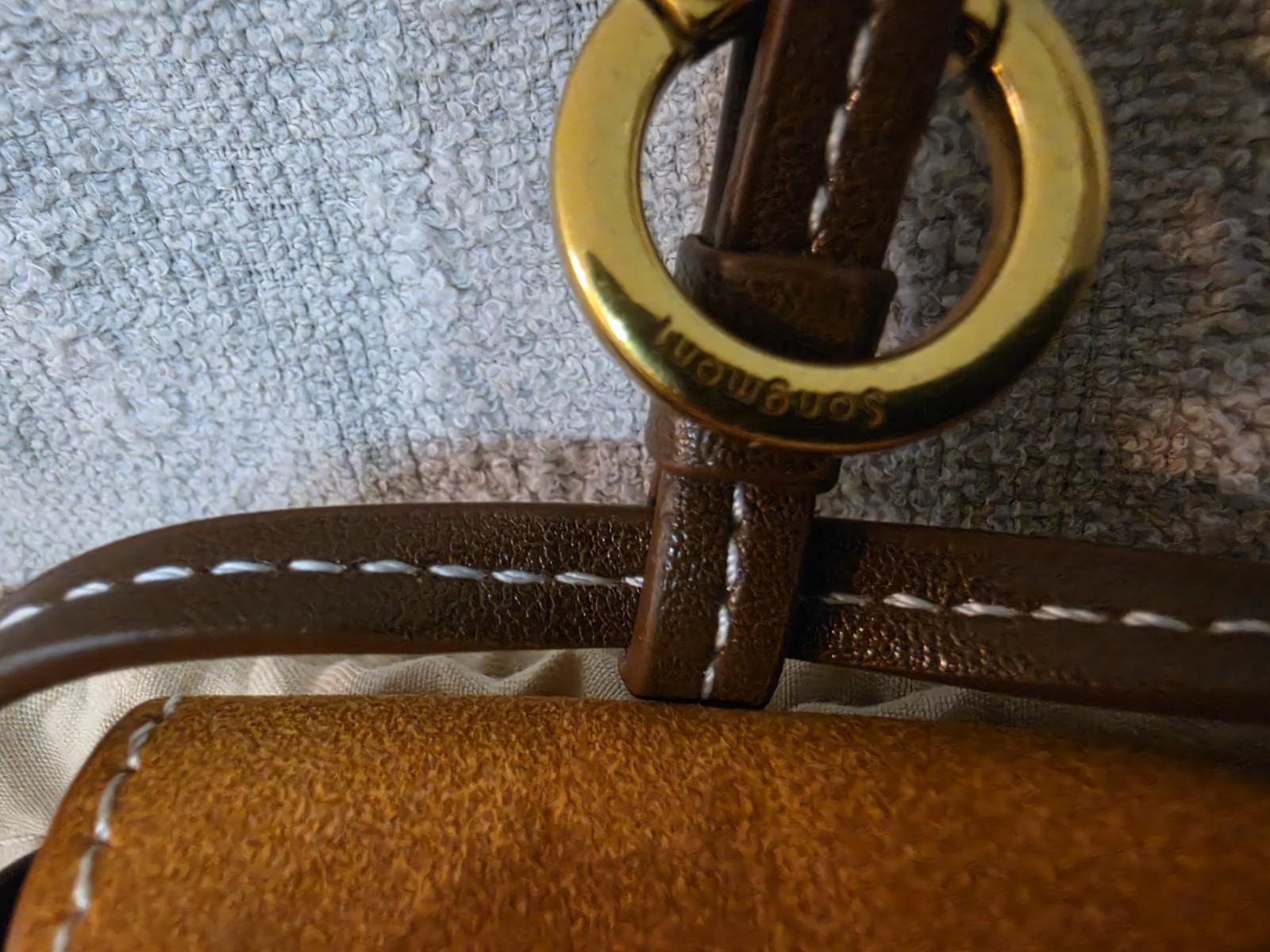 Songmont Brown earbud case with dust Bag.