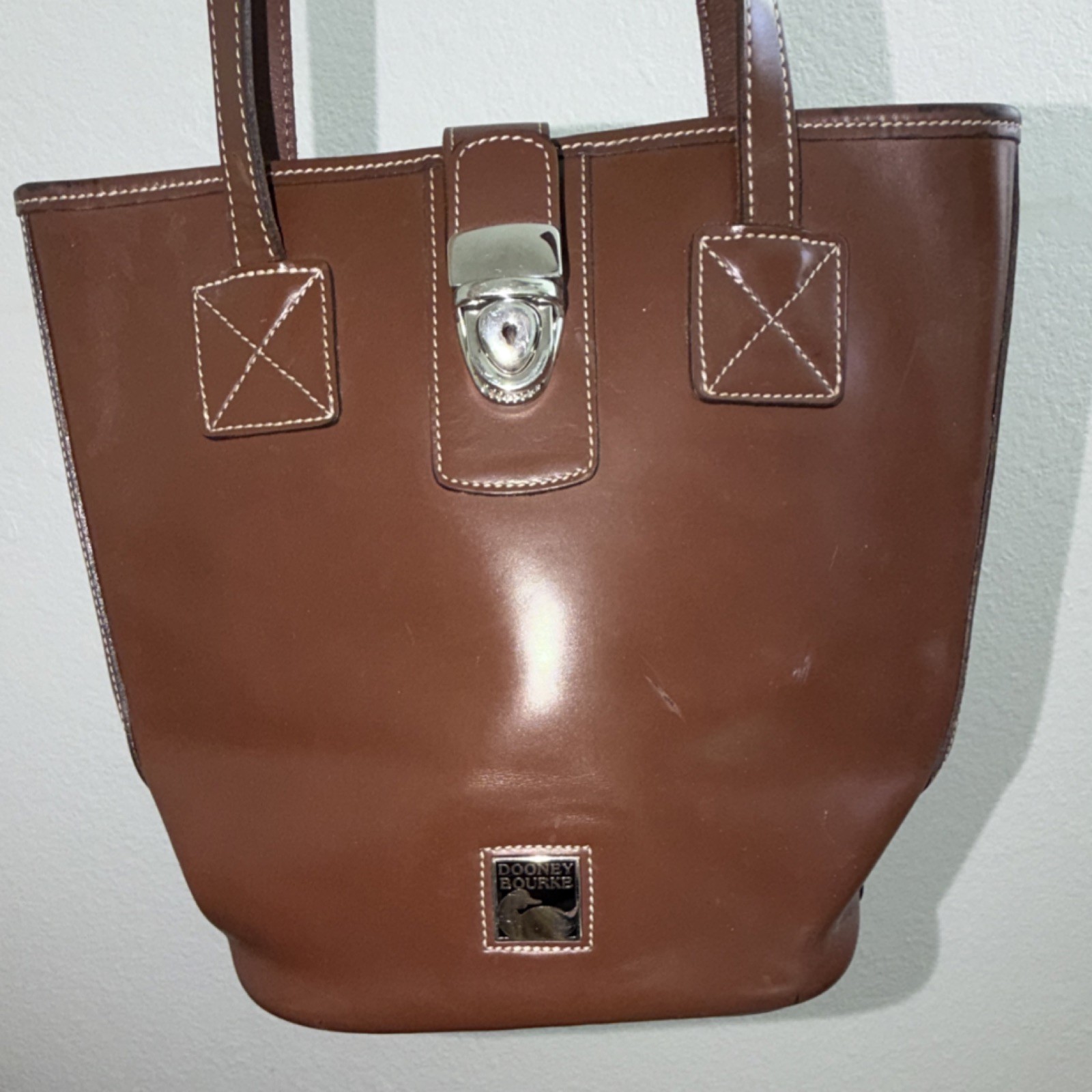 Dooney & Bourke Brown Shoulder Bag with Buckle Accent and Turn Lock Closure