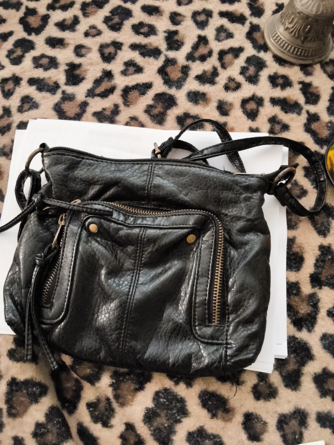 Based on the image provided, this black crossbody or shoulder bag features a…