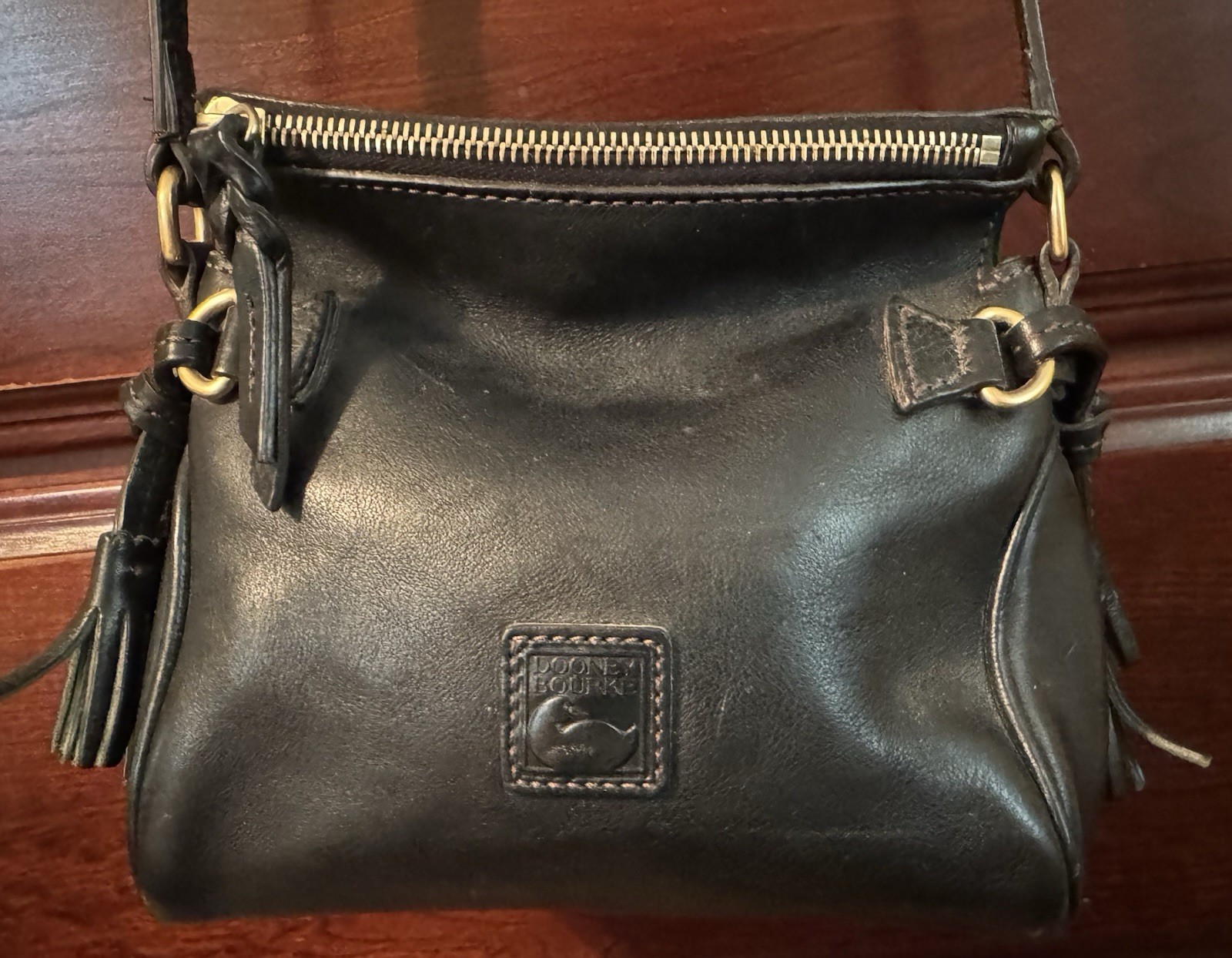 Dooney & Bourke Florentine Black Crossbody Tassel Red Lining adjustable Strap.