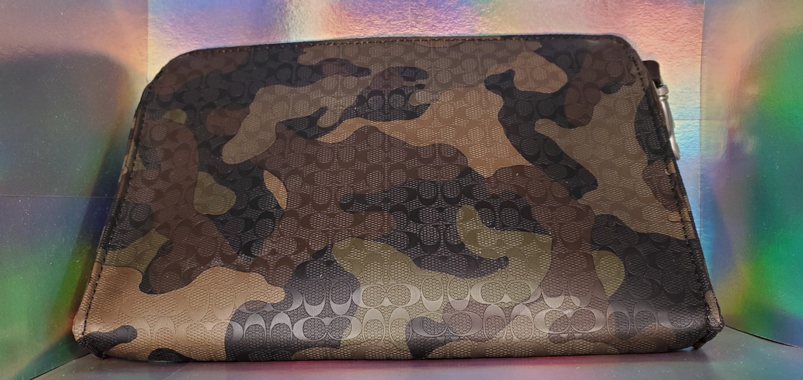 Coach pouch bag, green camouflage with front zipper, no wrist strap, looks great