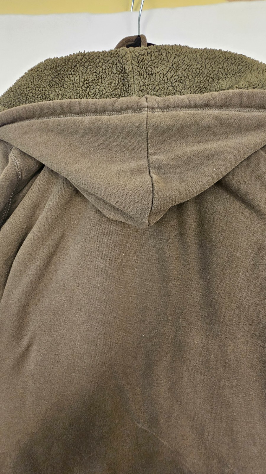 olive green full-zip hoodie features a cozy fleece lining, an adjustable drawstr