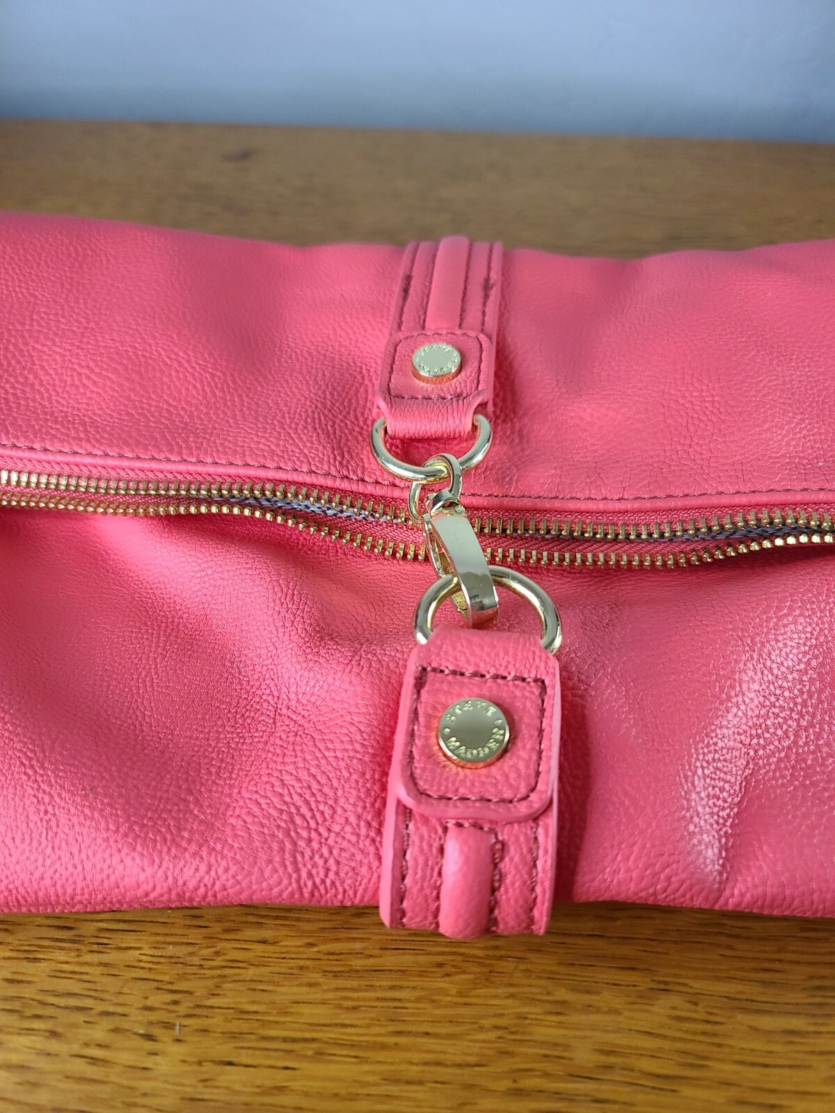 Elevate your style with this stunning Steve Madden clutch in a beautiful coral