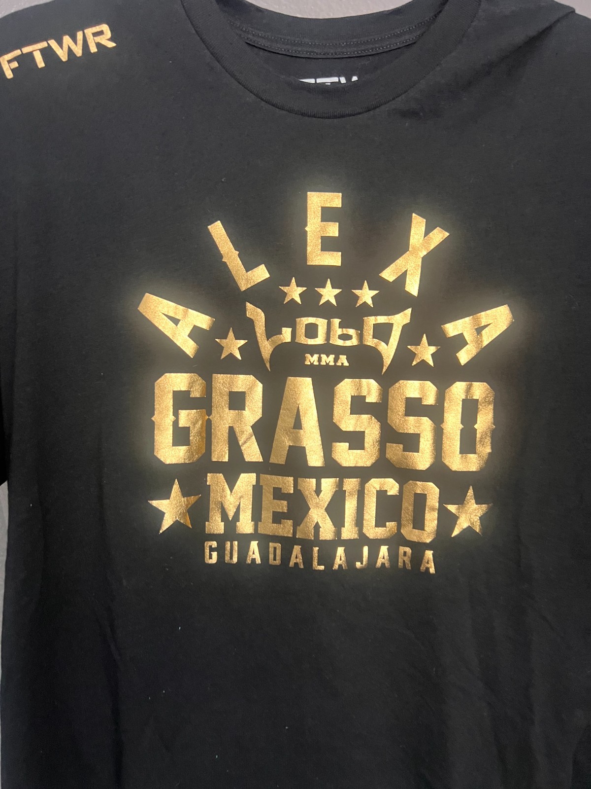 Black Alexa Grasso t-shirt with gold screen-printed graphics. Large