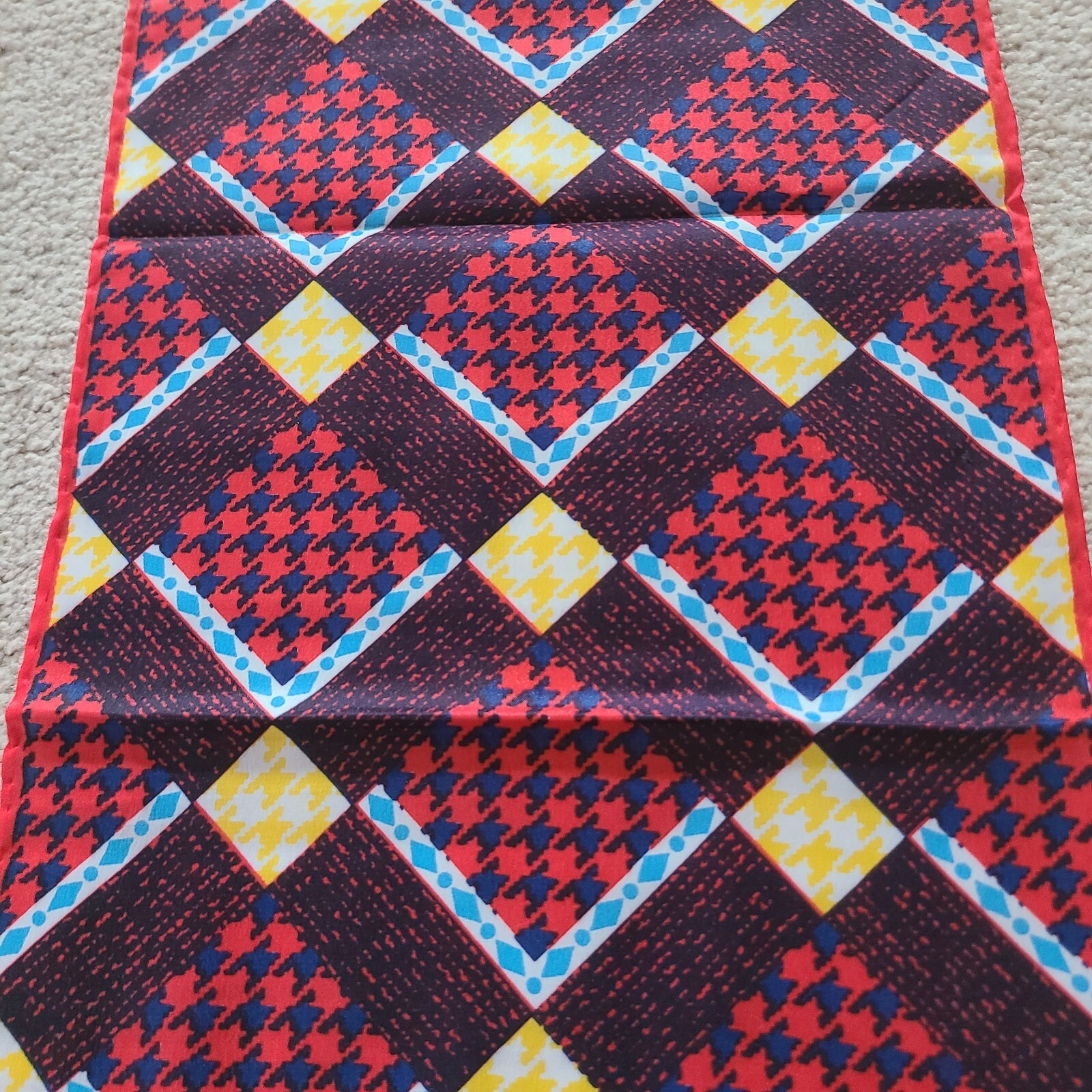 Scarf rectangular geometric pattern in red blue. Unmarked. 43 x 9.75 in.
