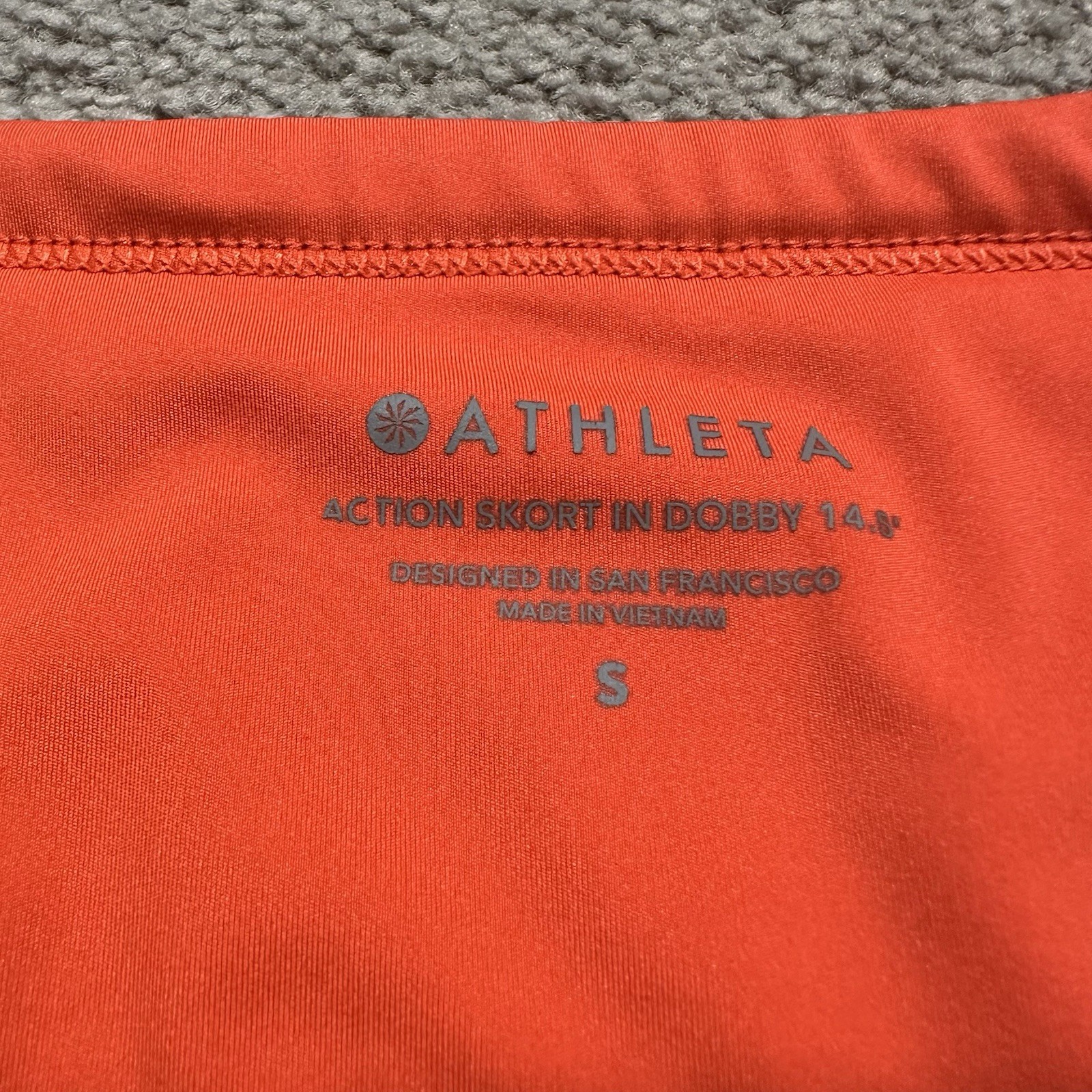 ATHLETA Action Skort in Dobby 14.5 Womens Small Orange Pockets Stretch Athletic