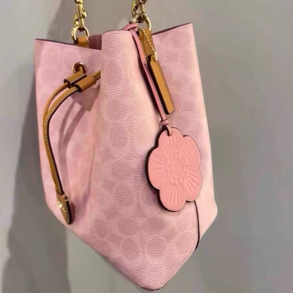 Coach CEA23 Rowan Bucket Bag In Signature Canvas With Charms Powder Pink