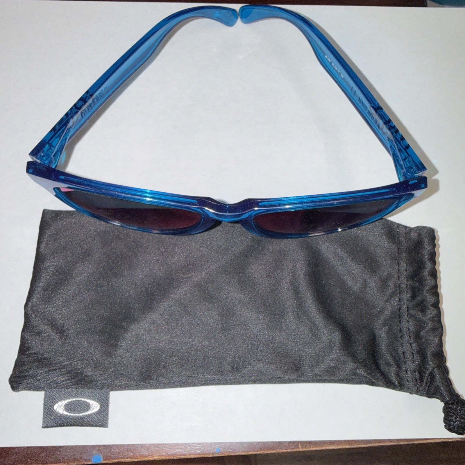 Used Oakley Frogskins BLUE FRAME Sunglasses model 24-356 lens have scratches.