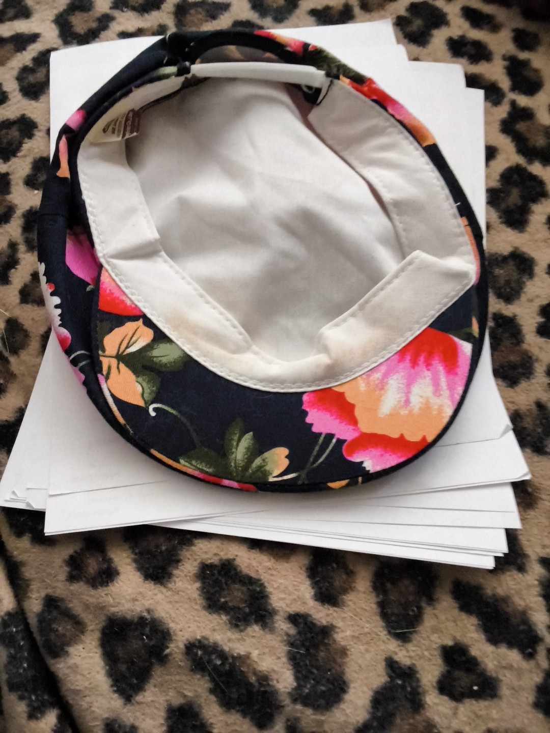 Based on the image provided, this item is a floral print cap, featuring large…
