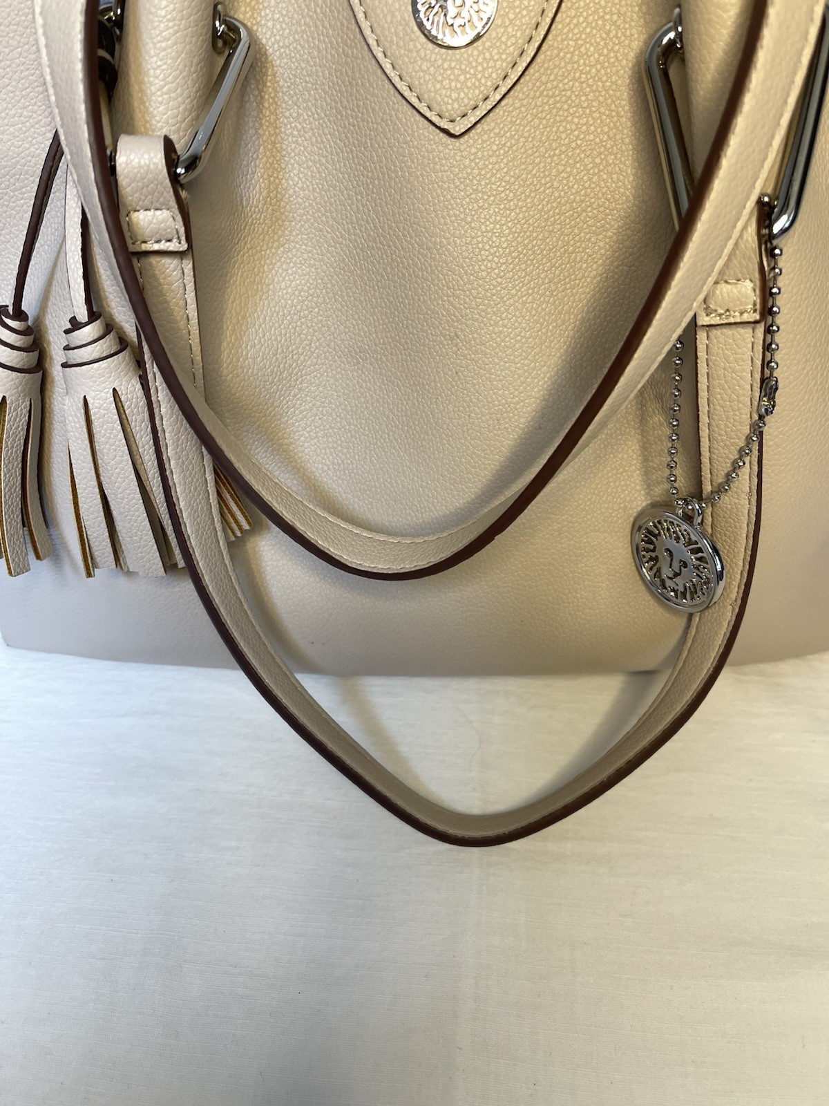 Anne Klein Taupe Vegan Pebbled Texture Tote with Lion and Tassel Charms