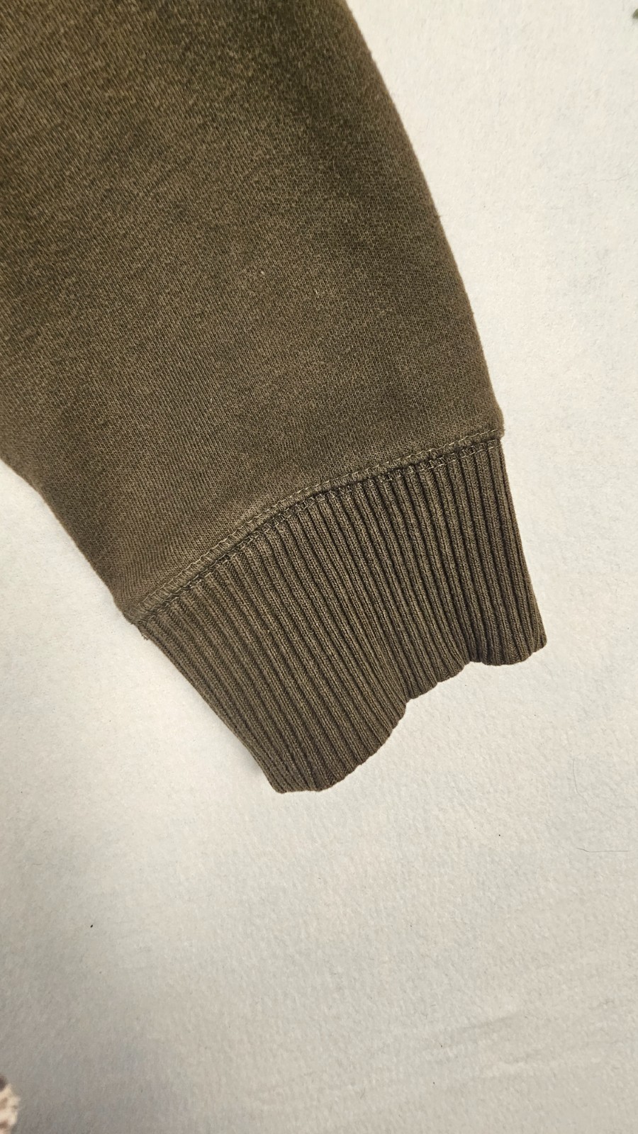 olive green full-zip hoodie features a cozy fleece lining, an adjustable drawstr