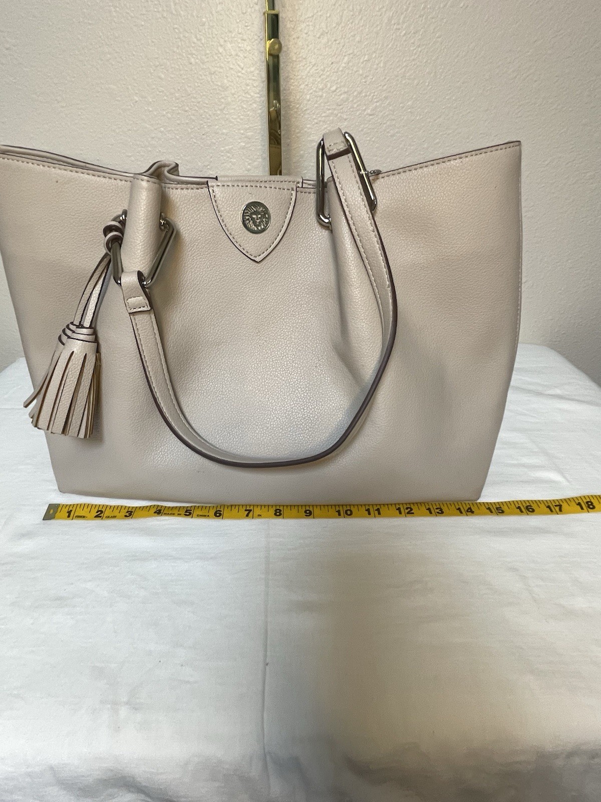 Anne Klein Taupe Vegan Pebbled Texture Tote with Lion and Tassel Charms