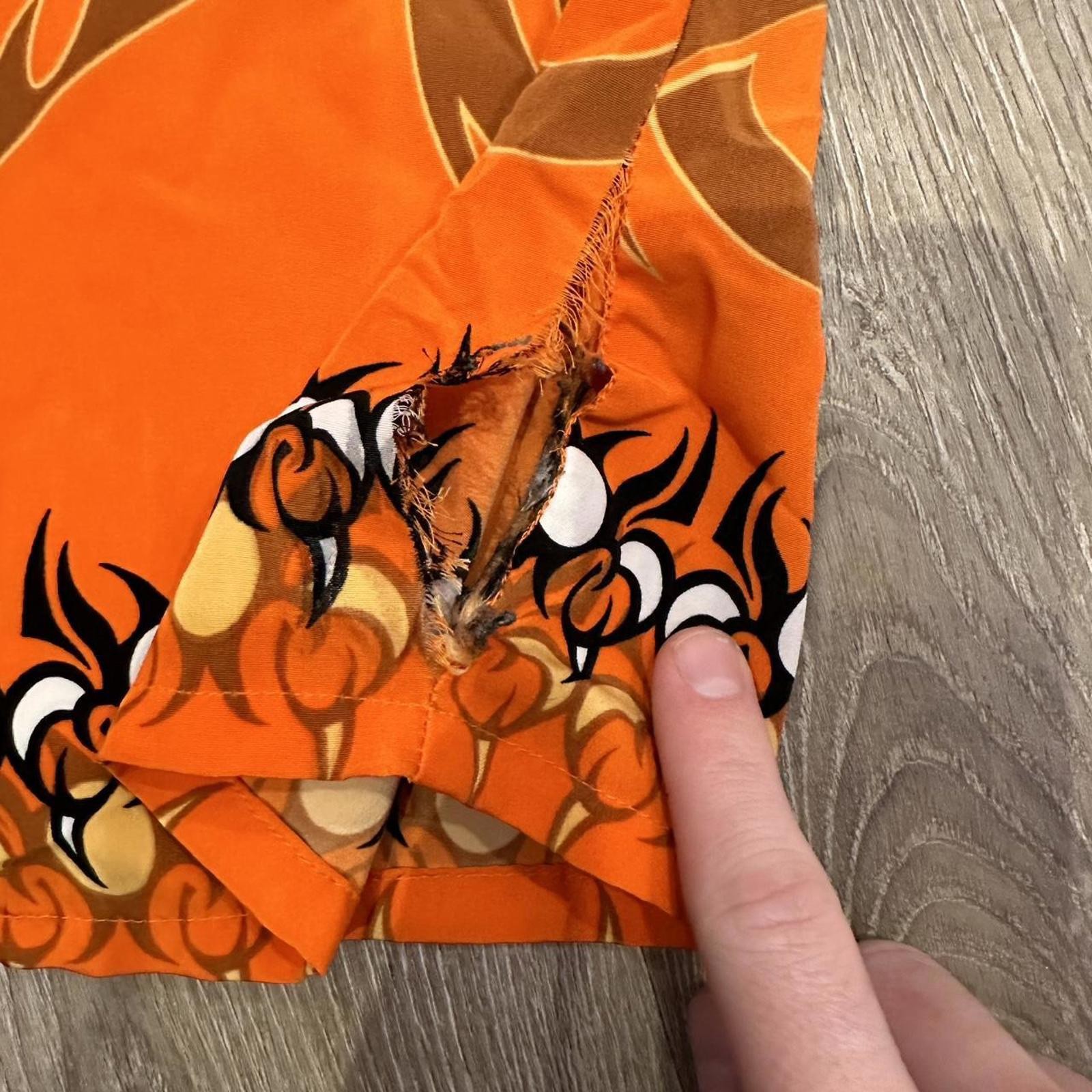 Orange and black dragon button up shirt with a small hole can be sewed size xl