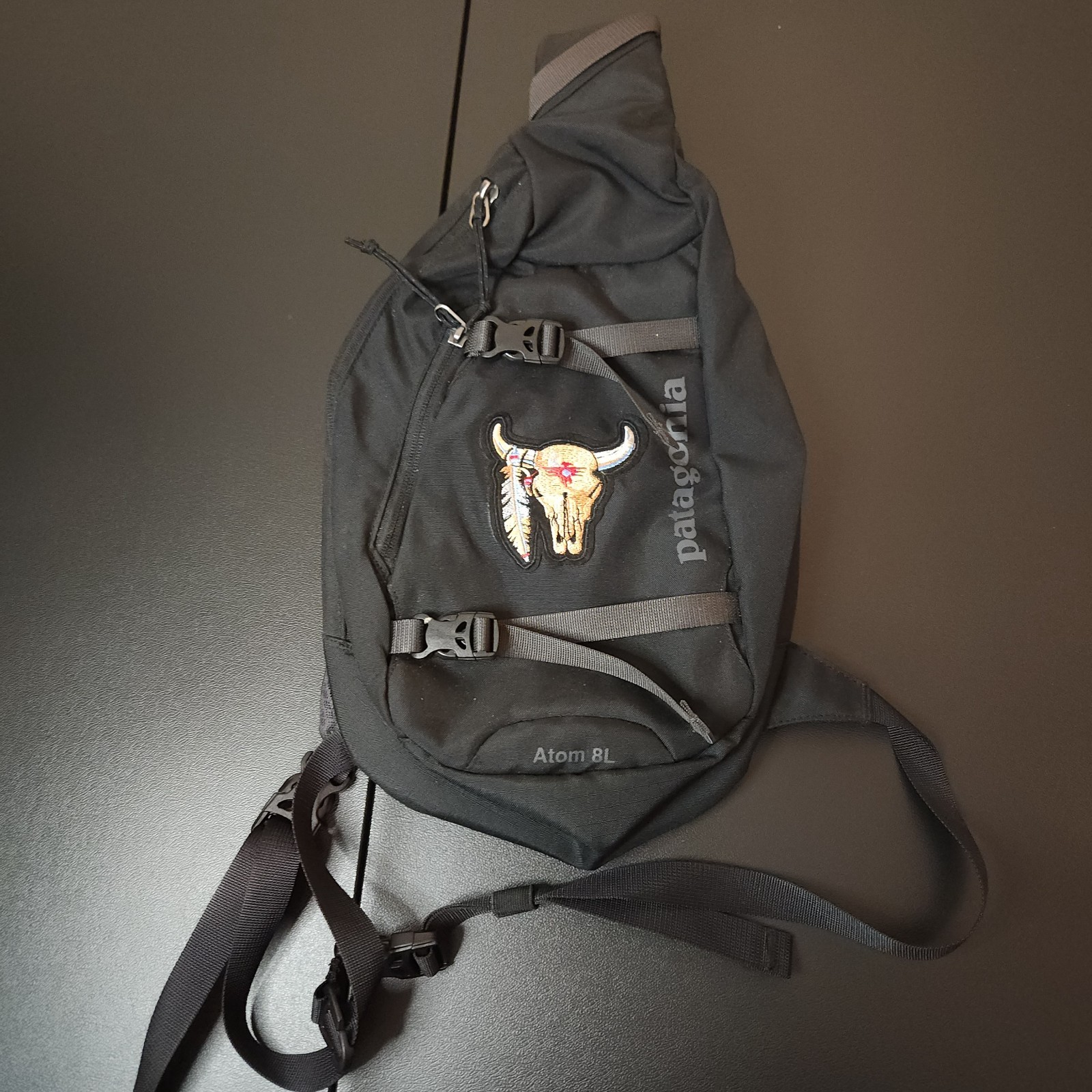 Patagonia Atom 8L Sling Bag Black Gray Crossbody Bull Skull Patch Hiking Travel