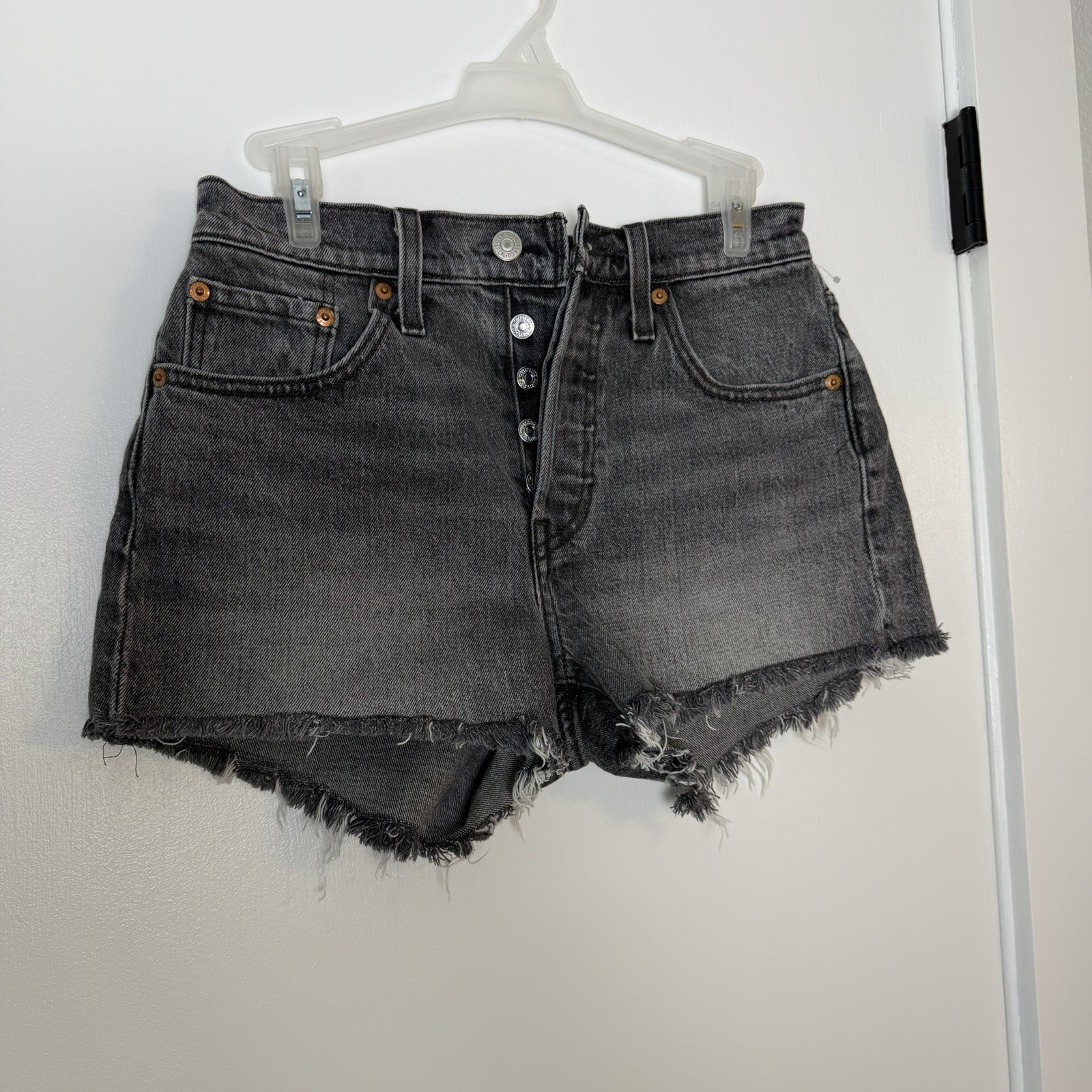 Women “Levi’s Premium 501” black cut off button up short shorts . Size W25