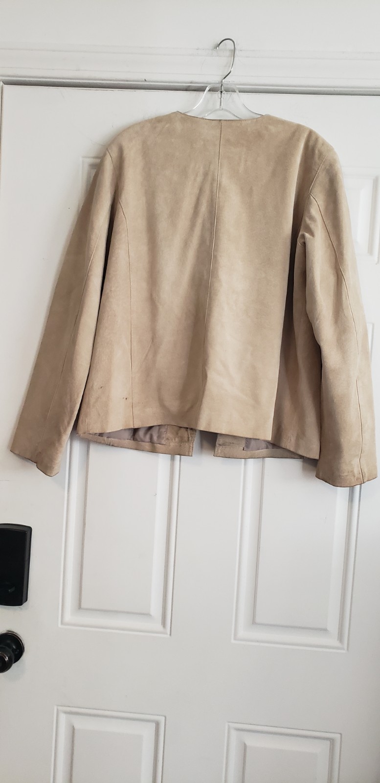 Merona beige collarless suede jacket. It features a minimalist, open-front…