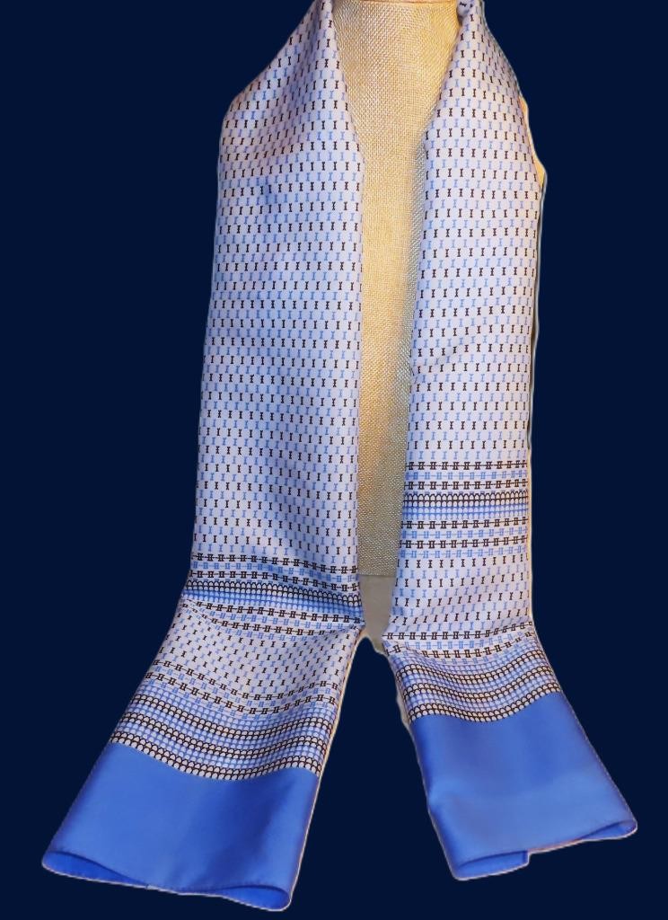 Oblong abstract scarf; blue tones, white; polyester; 54 x 10.5 inches
