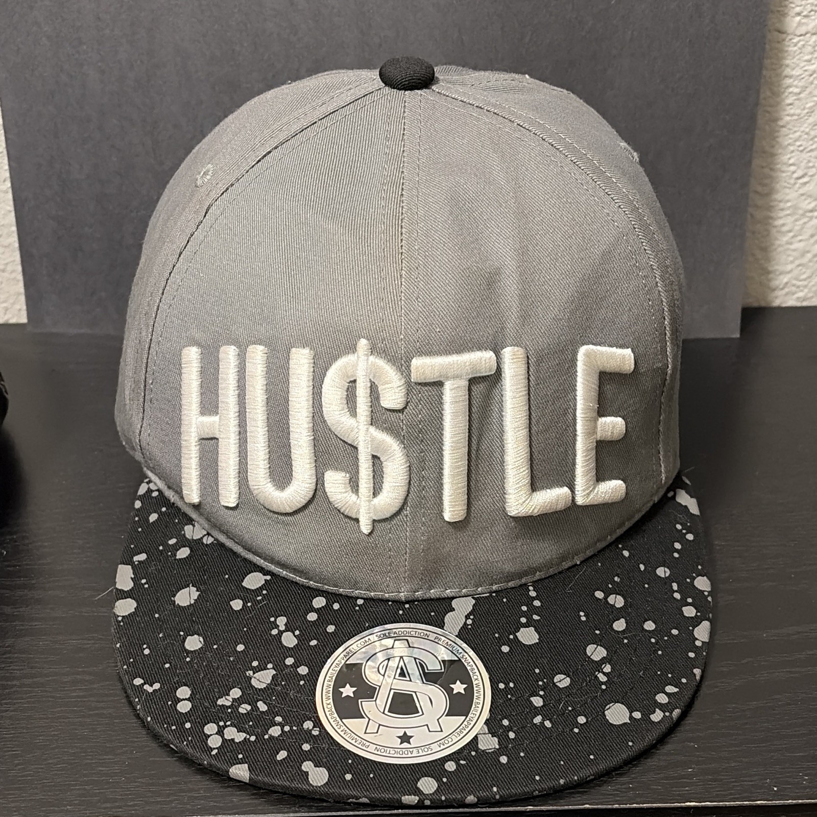 HU$TLE Logo Gray Snapback Hat Cap Adjustable Black Splatter Brim One Size
