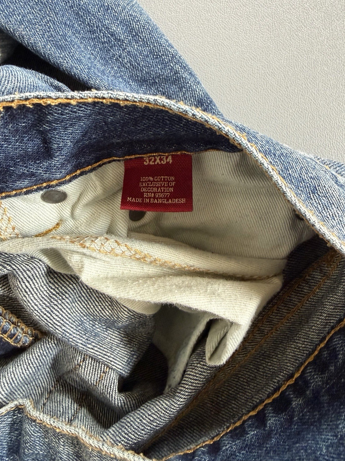 Arizona Jean Co. blue jeans featuring a distressed, light-wash denim style Mens