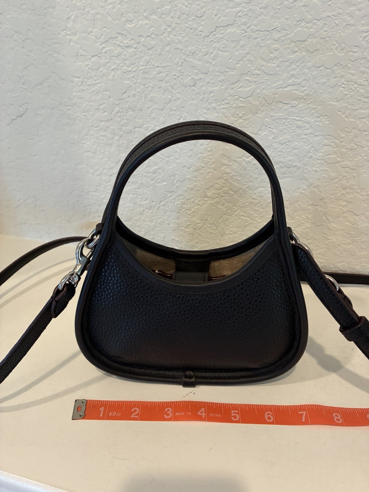 Coachtopia Mini Ergo Bag crafted from black pebbled Coachtopia leather