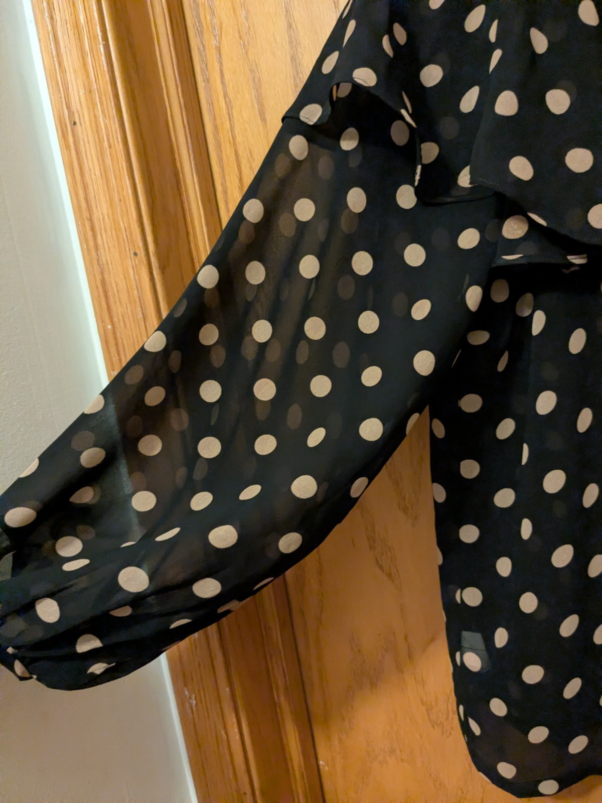 A black polka dot chiffon ruffle blouse