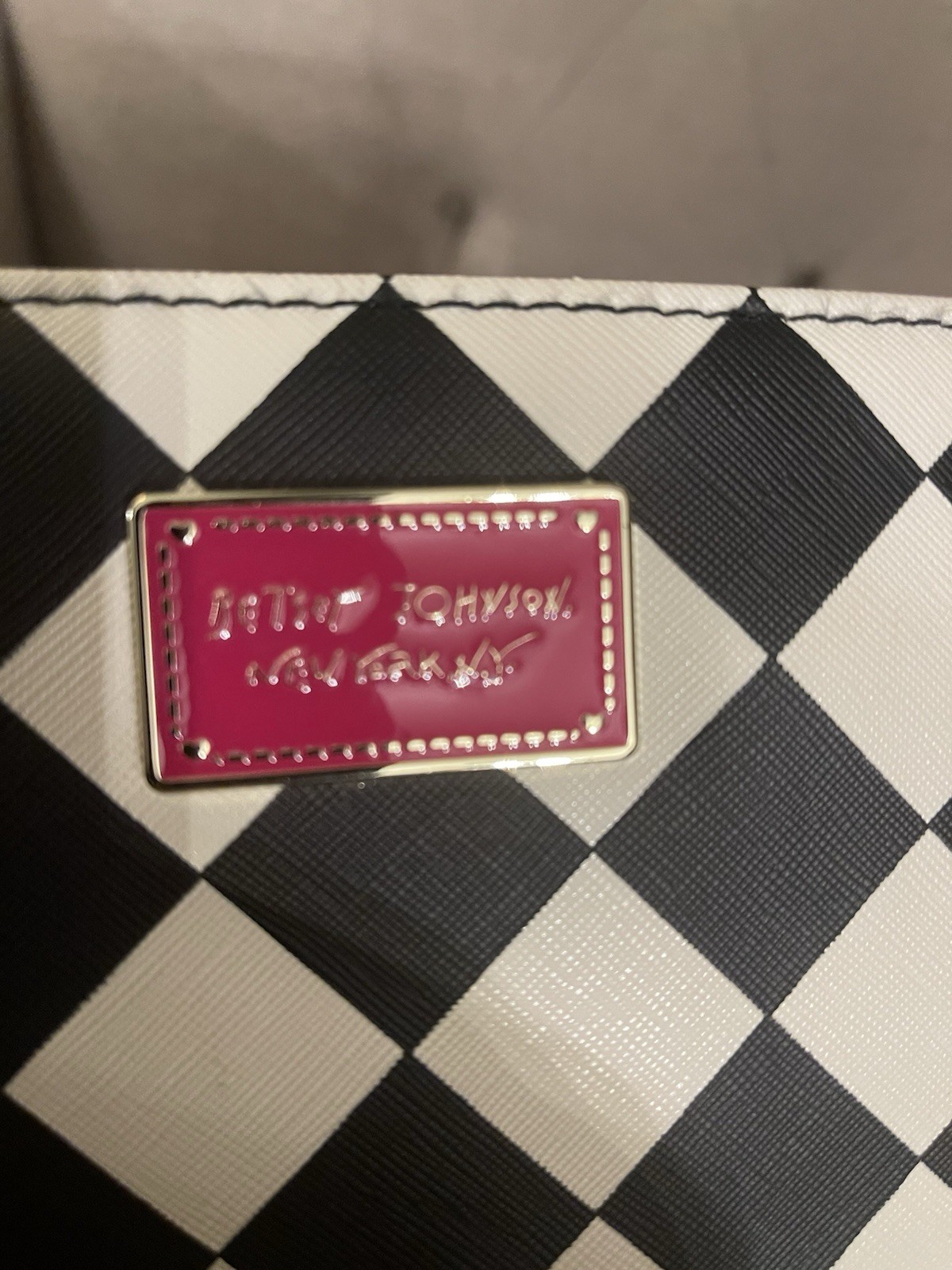 Betsey Johnson wristlet black and white checkerboard print and a pink logo