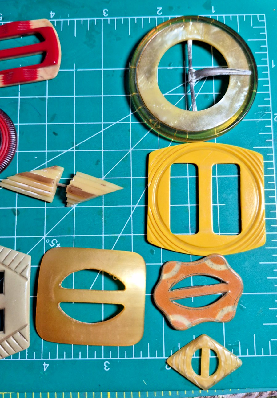 12 Vintage antique celluloid buckles or slides reds yellow art deco shapes
