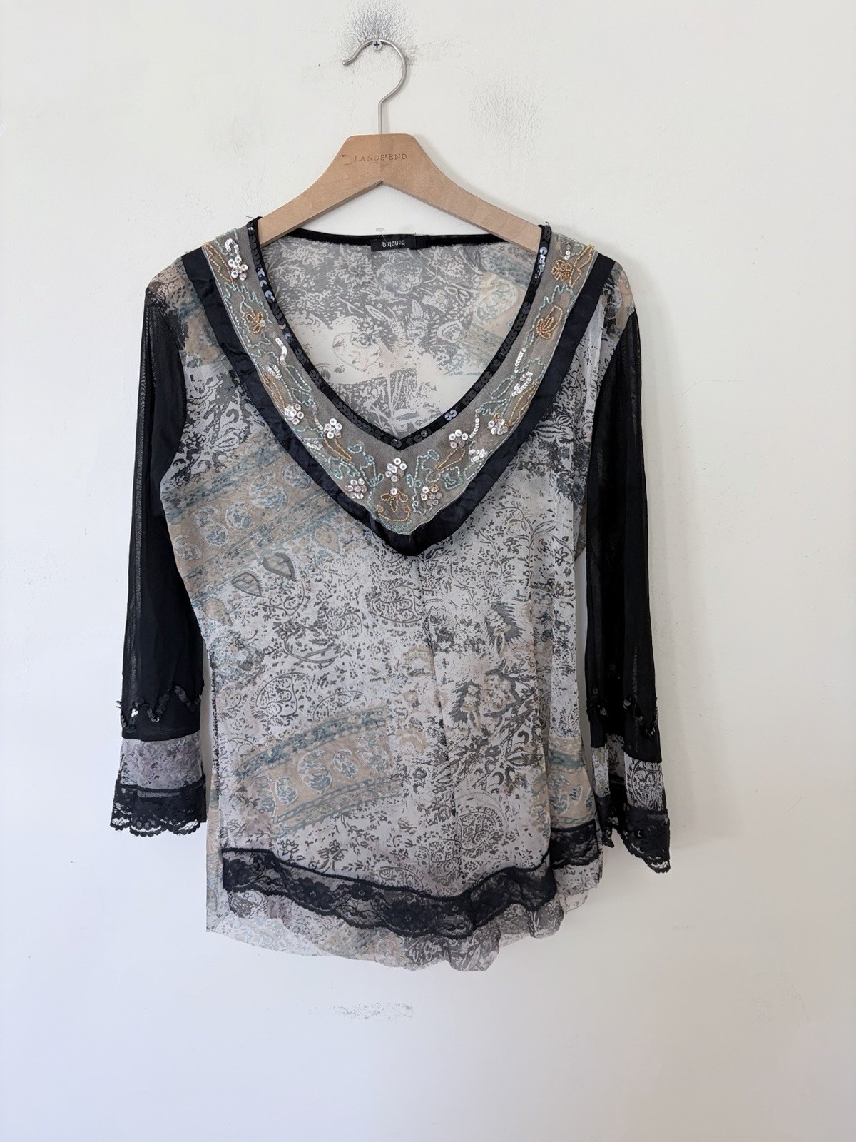 Vintage long sleeve top features a grey and black paisley print with intricate b