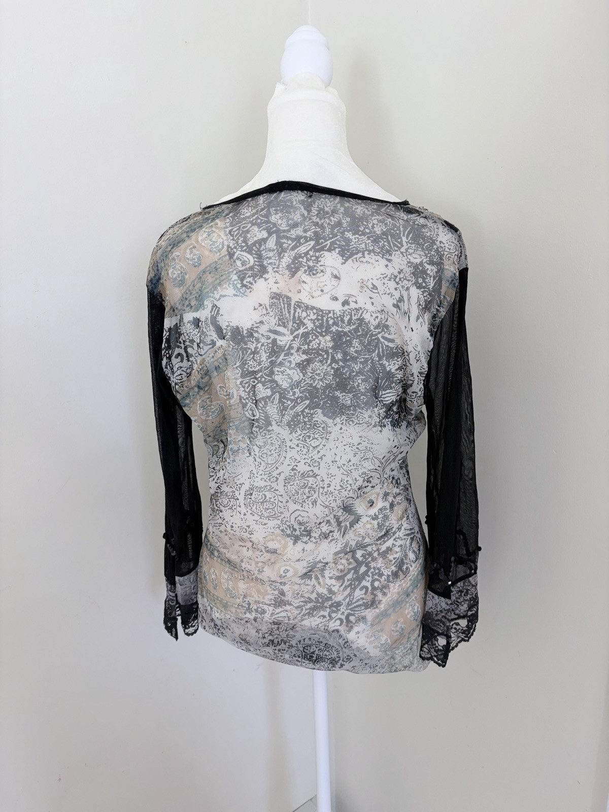 Vintage long sleeve top features a grey and black paisley print with intricate b