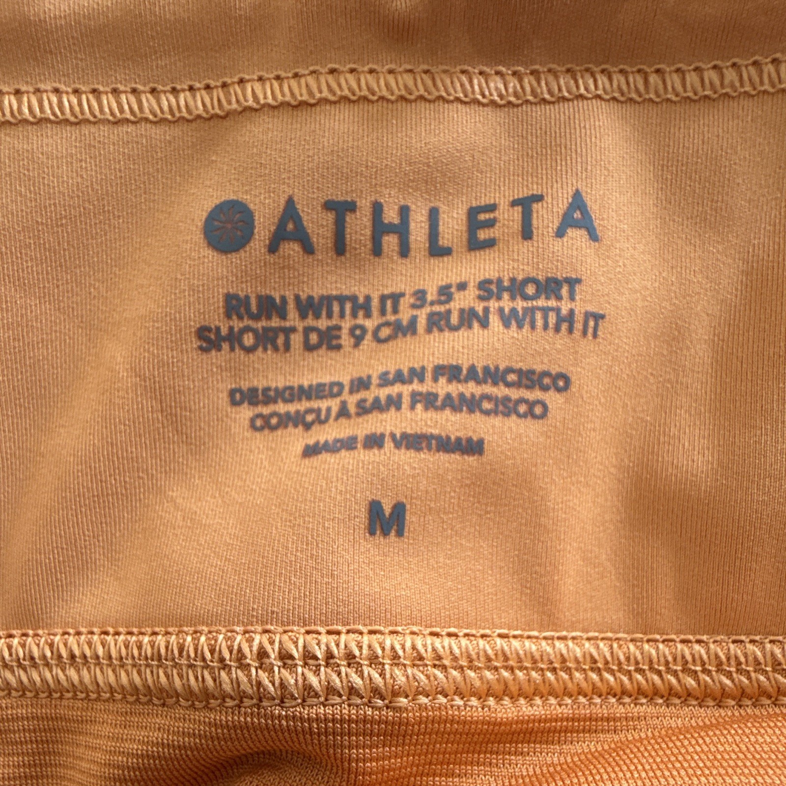 Athleta Women’s Run With It Orange 3.5in Running Shorts Zip Pockets Stretch