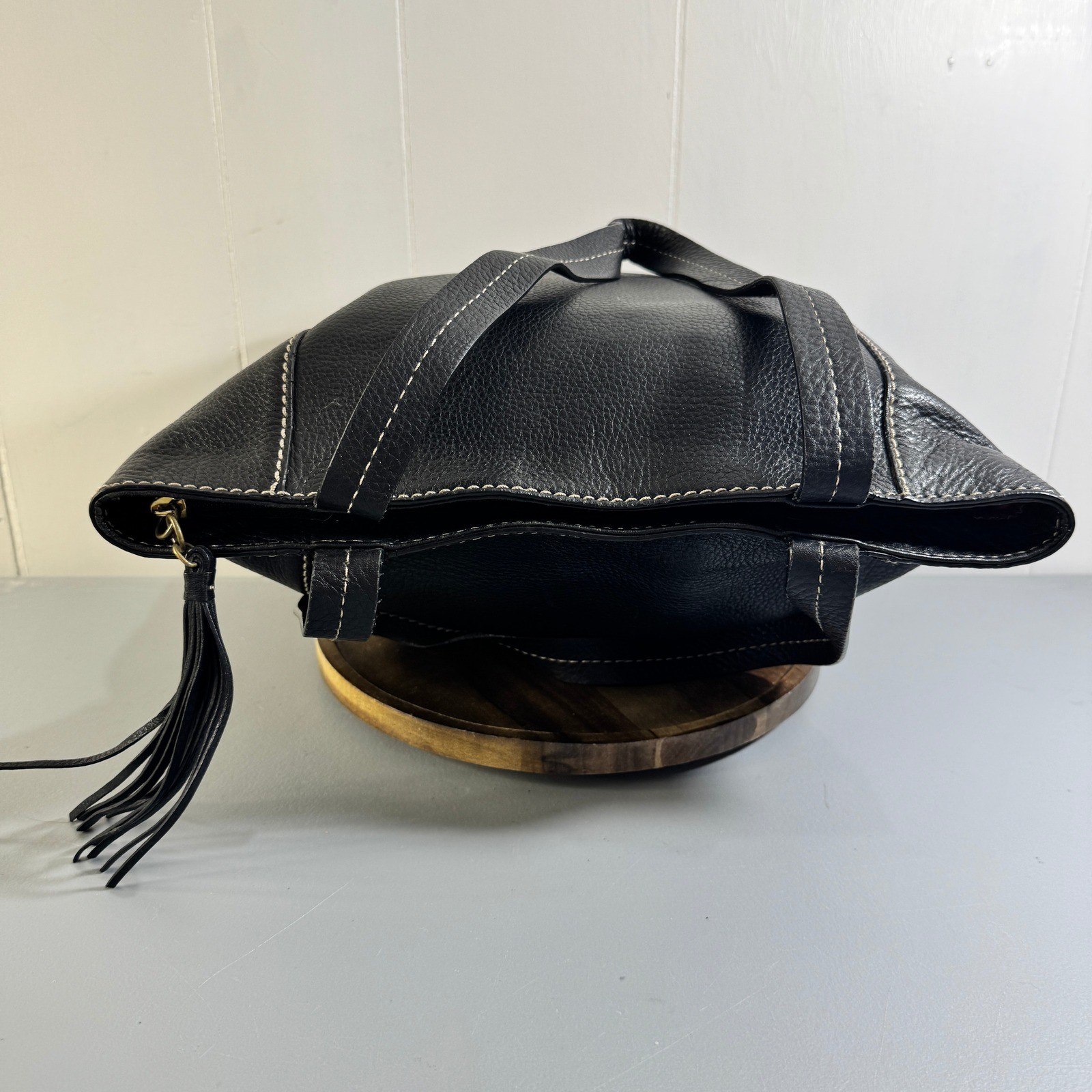 The Sak Black Leather Tote Bag With White Stitching And Tassel Accent Timeless