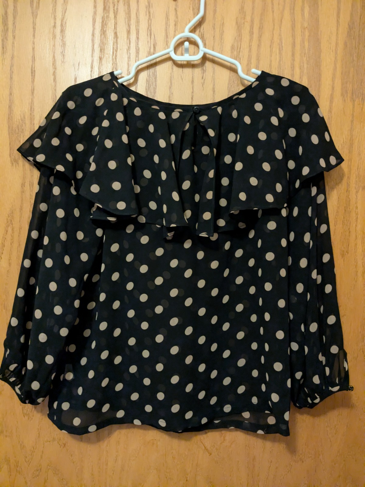 A black polka dot chiffon ruffle blouse