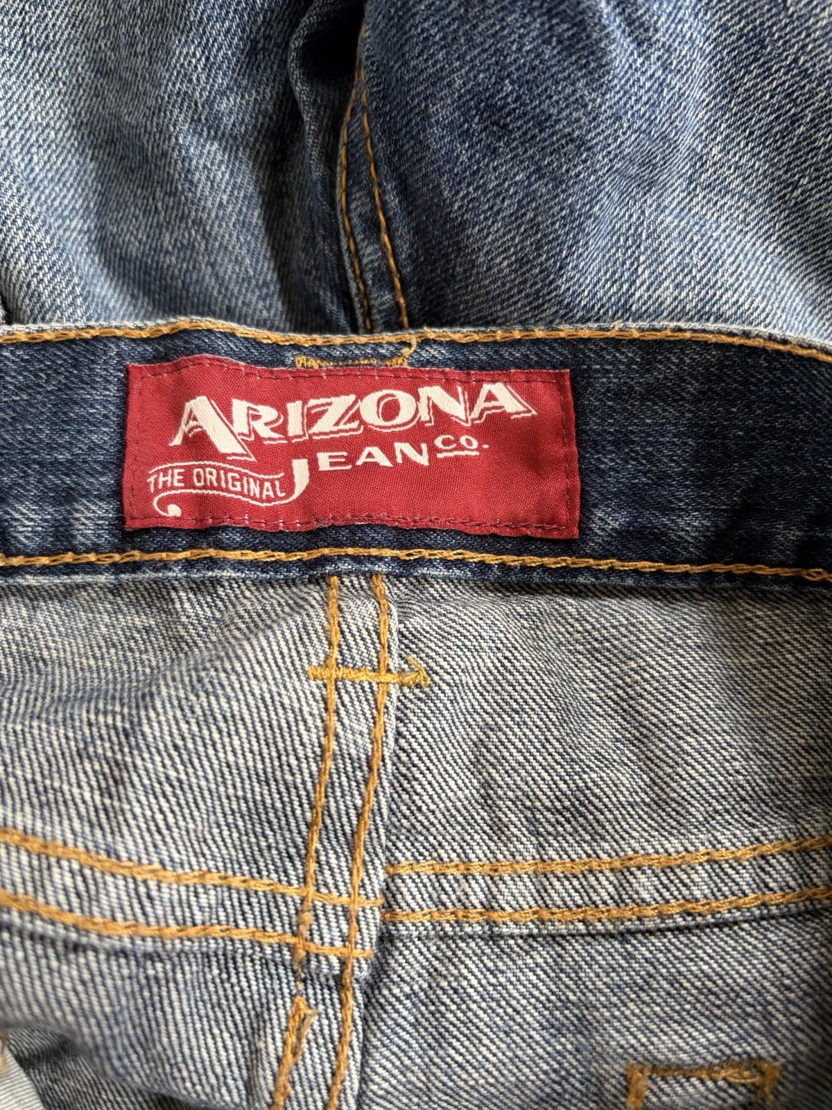 Arizona Jean Co. blue jeans featuring a distressed, light-wash denim style Mens