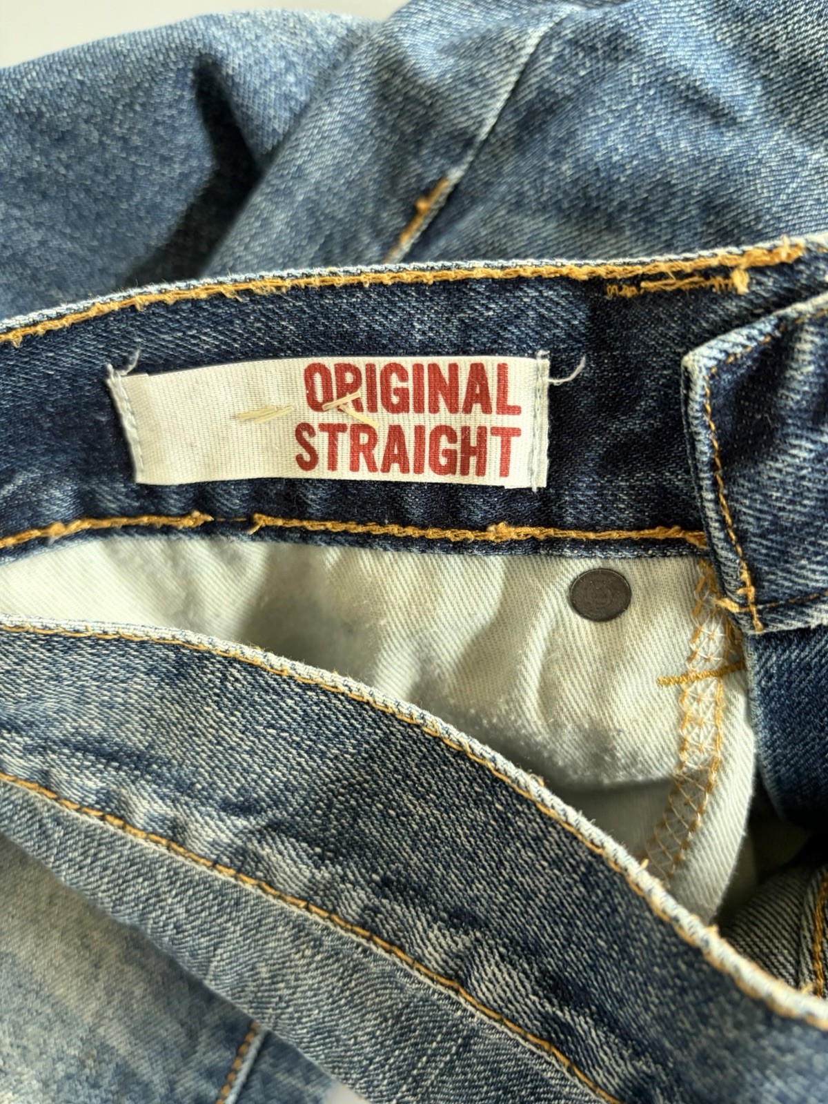 Arizona Jean Co. blue jeans featuring a distressed, light-wash denim style Mens