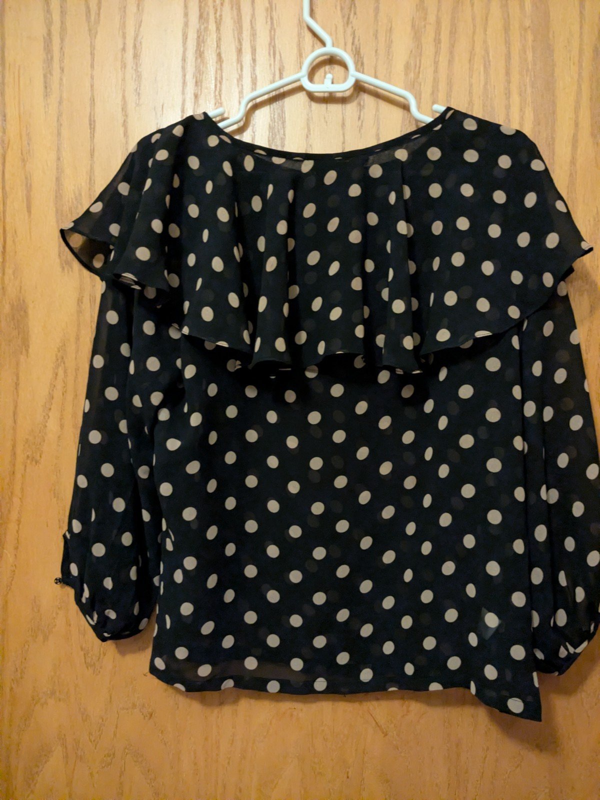 A black polka dot chiffon ruffle blouse
