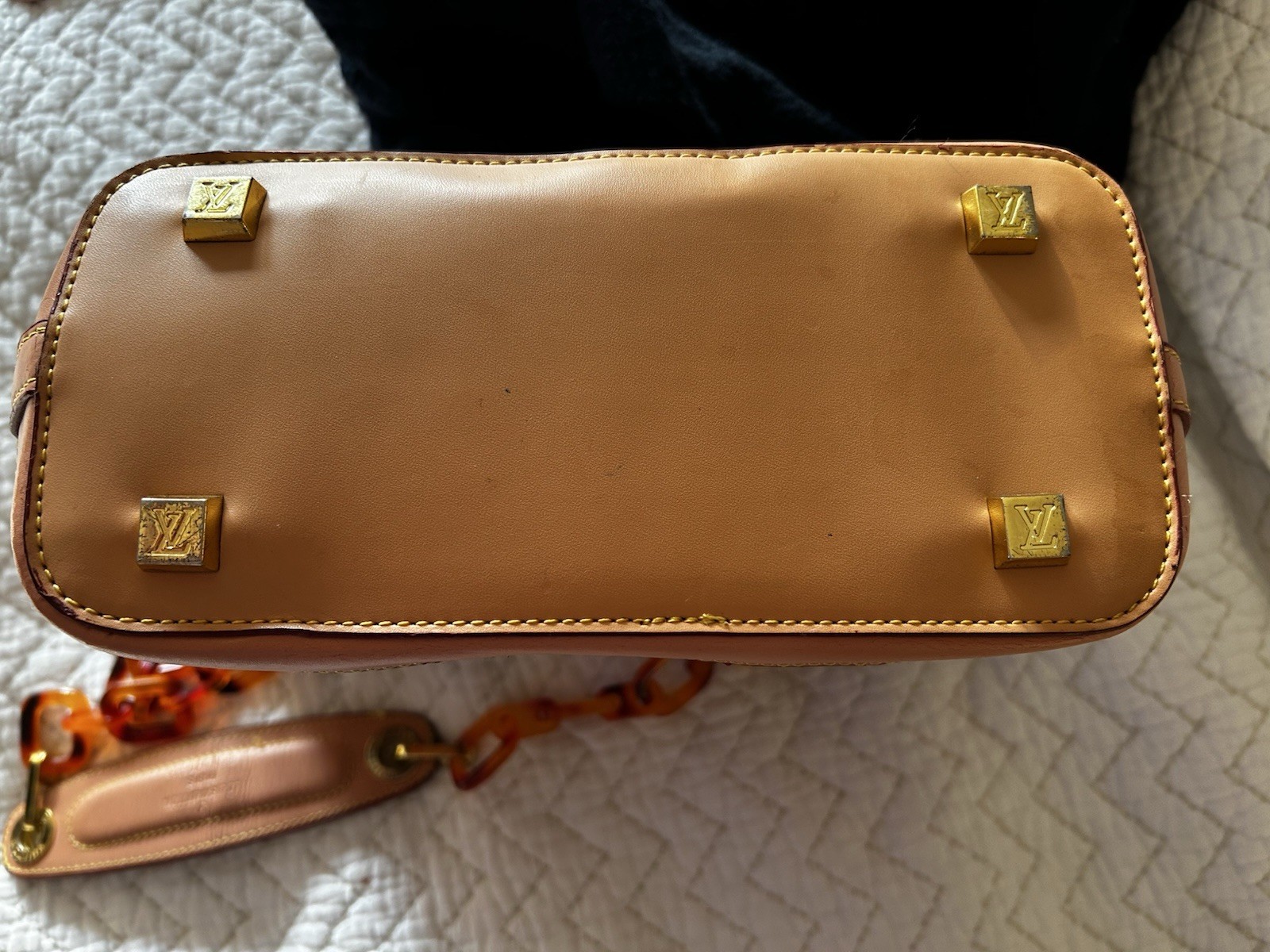 Purse vinyl exterior,amber-colored resin chain straps, and gold-tone hardware